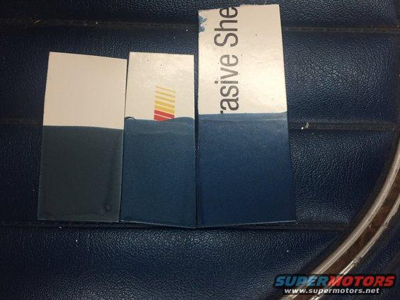 Three swatches with blue and white sections, one with red and yellow stripes, on a dark blue textured surface