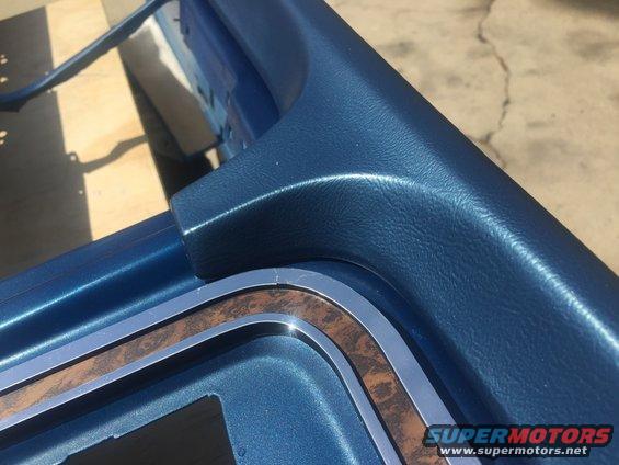 Blue dashboard trim with wood grain accent from a 1978 Ford Bronco