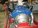 1969 Ford Mustang - Engine assembly on a stand, likely a 1969 Ford Mustang 428 CJ, with visible carburetor and exhaust components.