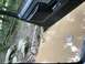 1989 Ford Bronco - The interior of a vehicle is shown from the driver's perspective, looking out at a muddy puddle.