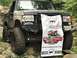 1989 Ford Bronco - This heavily modified Ford Bronco is shown off-road with a banner celebrating an anniversary.