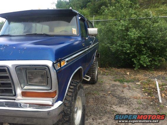 Blue 1978 Ford Bronco front quarter view with sun visor