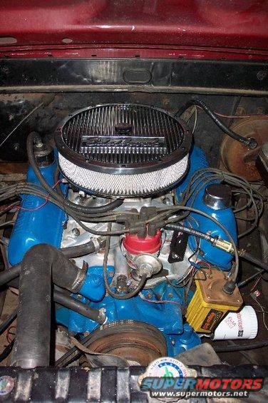 1968 Ford F-100 engine bay with blue valve covers, chrome air cleaner, and red distributor cap