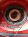 1989 Ford Probe - A detailed view of a vehicle's headlight housing, showing internal components and surrounding red bodywork.