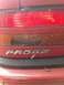 1989 Ford Probe - Damaged rear taillight assembly on a red car with 'PROBE' badging.