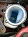 1989 Ford Probe - The coolant reservoir is filled with blue fluid. The Supermotors.net logo is visible in the lower right corner.