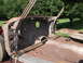 1961 Ford Starliner - The interior of a heavily rusted car body is visible, with the floor pan and firewall exposed.