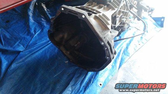 Transmission housing and input shaft visible, resting on a blue tarp