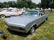 1971 Ford Ranchero - Silver 1966 Dodge Charger at an outdoor car show with other vehicles present.