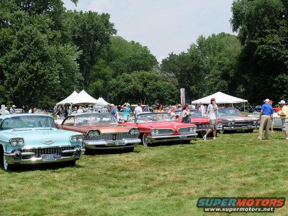 Light blue 1958 Cadillac Eldorado Brougham convertible parked on grass, front view