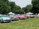 1971 Ford Ranchero - Several vintage automobiles are displayed on a grassy field under a cloudy sky.
