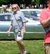 1971 Ford Ranchero - Woman walks past a silver car at an outdoor event with other people in the background.