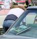 1971 Ford Ranchero - A man wearing a straw hat and back brace examines a framed picture placed on the dashboard of a 1971 Ford Ranchero.