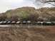 1991 Ford Bronco - A convoy of off-road vehicles stops in a shallow riverbed during an outing.