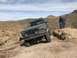 1991 Ford Bronco - This 1991 Ford Bronco is navigating a challenging off-road trail in a desert landscape.