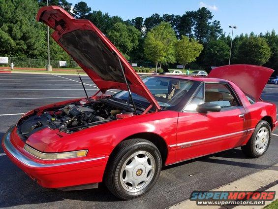 1991 Buick Reatta coupe, red, hood and trunk open, parked outside