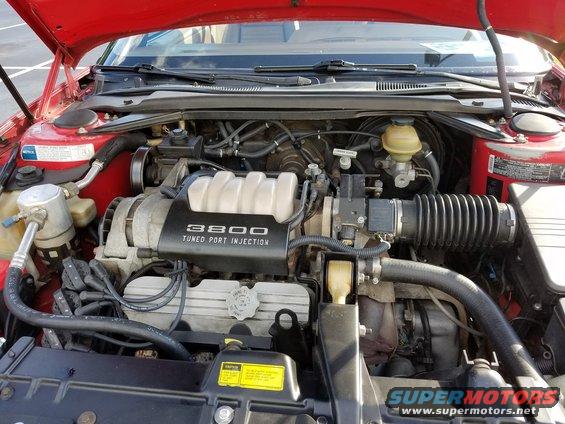 engine bay with "3800 TUNED PORT INJECTION" cover visible