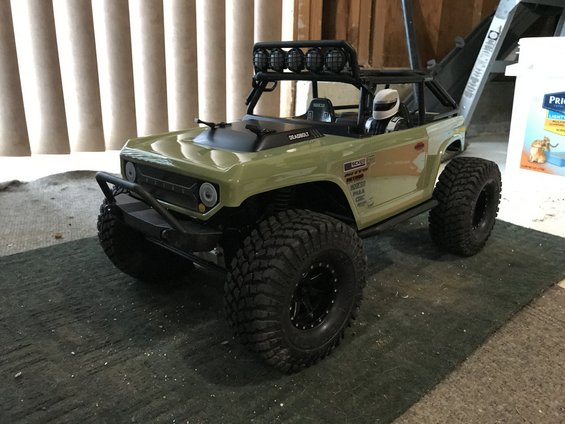 RC rock crawler toy with large tires and roof lights