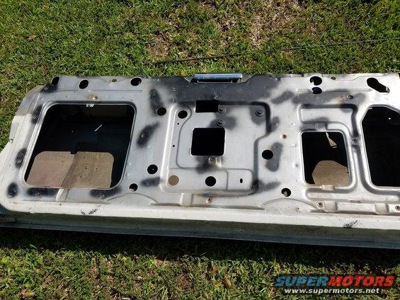 Interior of a car door with spray-painted black markings