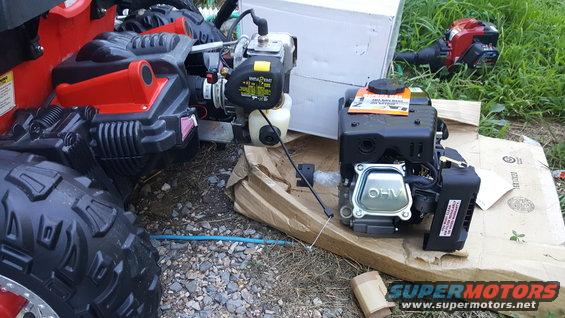 lawnmower engine and parts on cardboard