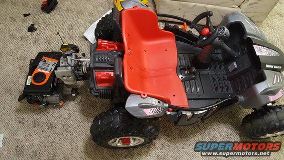 Red seat and detached engine on toy dune buggy