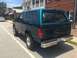 1996 Ford Bronco - Rear view of a dark green 1996 Ford Bronco parked on a street.