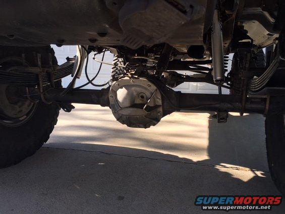 Undercarriage view of leaf springs and differential. Supermotors.net logo visible