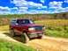 1995 Ford Bronco - 1995 Ford Bronco on a dirt road, with a field and trees under a cloudy sky.