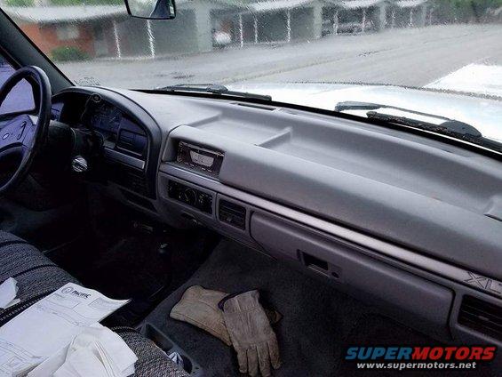Interior dashboard with radio and glove compartment. XL trim visible