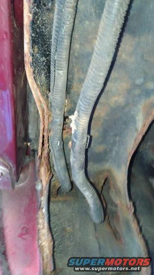 Corroded metal and wiring harness with Supermotors.net logo
