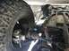 1970 Volkswagen Beetle - The underside of a vehicle is visible, with focus on the tire and suspension system.