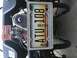 1970 Volkswagen Beetle - Close-up of a motorcycle engine and its Michigan license plate.