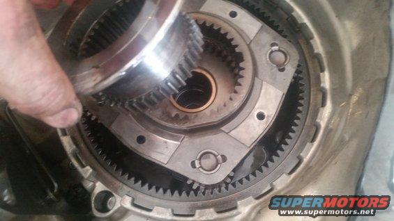 Close-up of transmission planetary gear set with a hand holding a gear