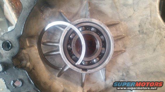 Close-up of a bearing inside a metal housing with a retaining ring