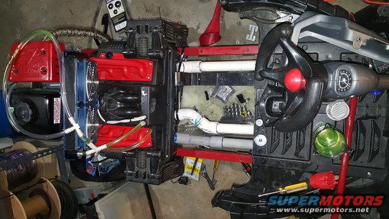 Toy car interior with added plumbing and red engine-like parts