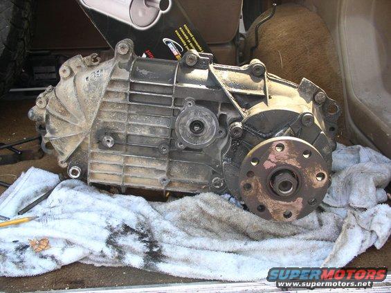 transfer case resting on a towel, with a new muffler box in the background