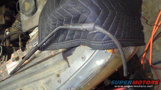 An vacuum hose repair from the railroad's "auto mechanic" piece of fuel line slid over the leaky vacuum line then black rtved in place. (It was still leaking like this)