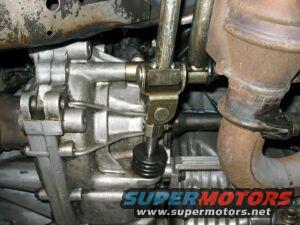 Underside view of a car's transmission shift linkage mechanism