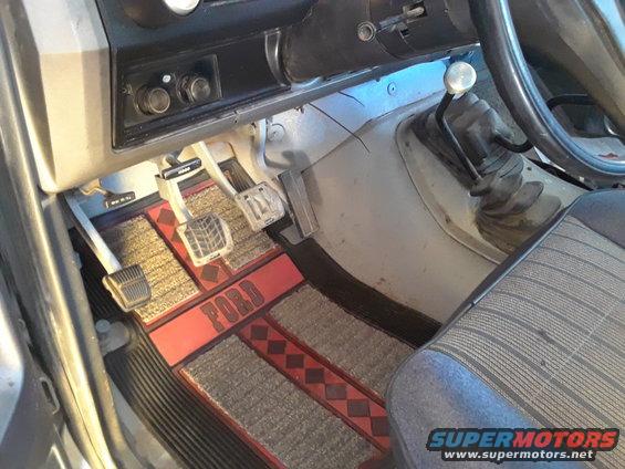 1985 Ford Bronco interior showing pedals and "FORD" branded floor mats