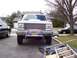 1990 Ford Bronco - This Ford F-150 features a prominent chrome grille and a brush guard with auxiliary lights.