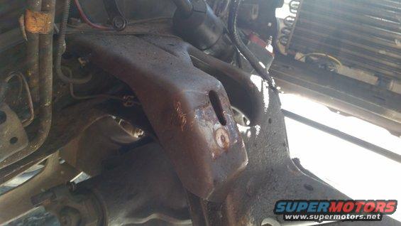 Rusty engine mount bracket with bolt hole