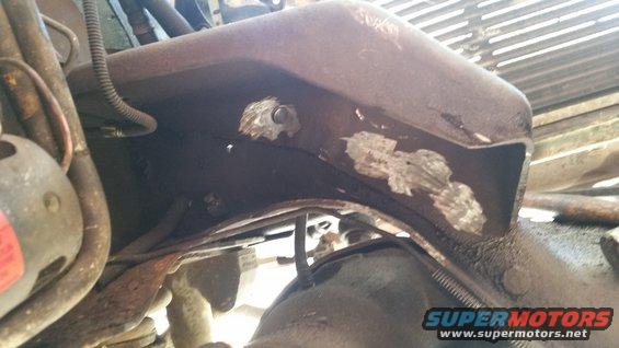 close-up of rusty vehicle frame with some engine parts visible