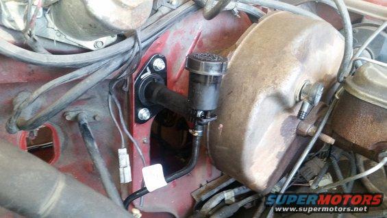 Clutch master cylinder and brake booster assembly in red engine bay