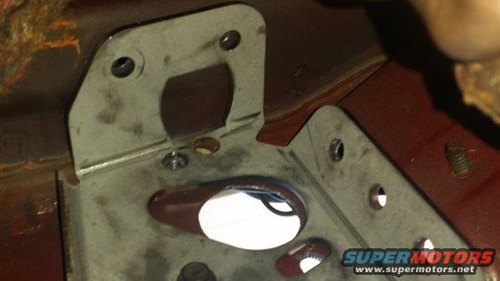Metal bracket with holes and a red painted surface