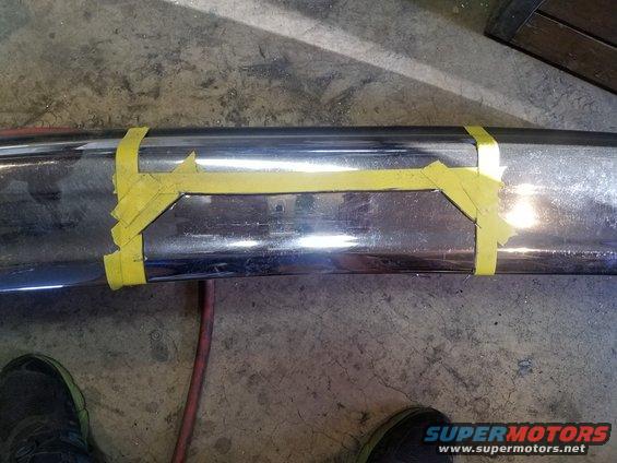 Chrome bumper marked with yellow tape for modification