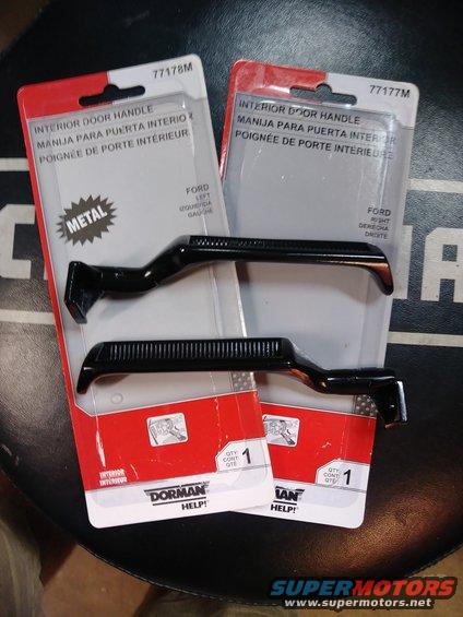 Two black Ford interior door handles in packaging. One is for the left side, the other for the right