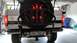 1995 Ford Bronco - The rear of a 1995 Ford Bronco is shown, a spare tire and illuminated brake lights.