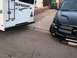 1992 Jeep Wrangler - A black pickup truck is parked next to a white Sunseeker RV in a driveway.