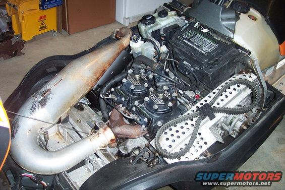 Snowmobile engine with "Arctic Cat 900" badges visible