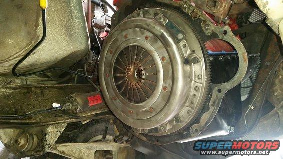 Close-up of a vehicle's clutch and flywheel assembly, showing the pressure plate and splined input shaft area